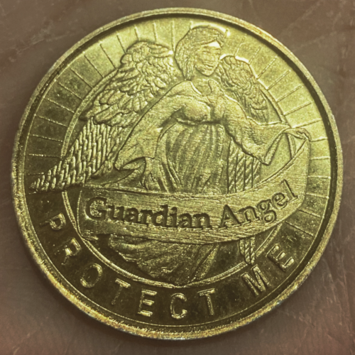 A gold coin stamped with an angel and the words 