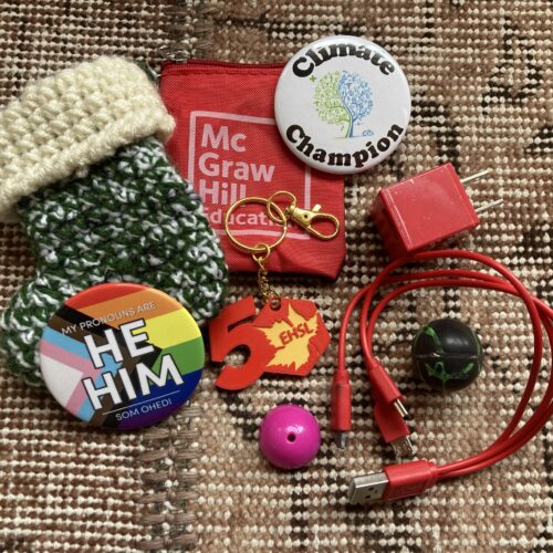 Photo of pins, a key chain, a knitted stocking, a charger, and two balls