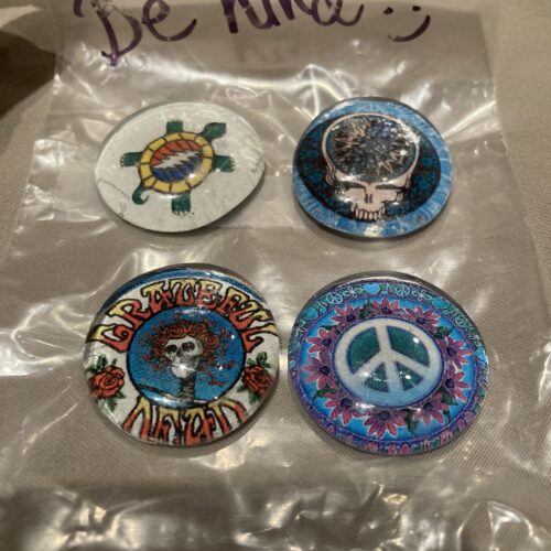 A photo of four grateful dead pins