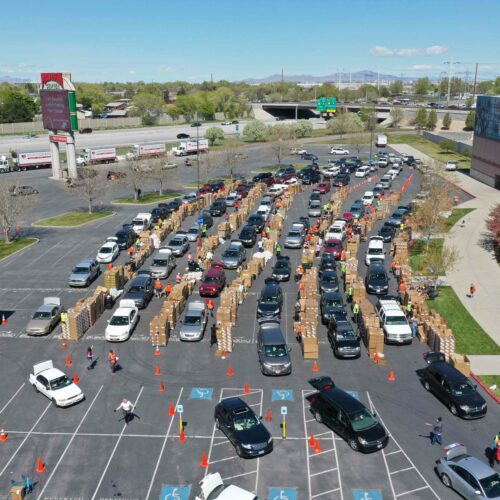 A photo of cars lined up in a parking lot to donate food to the Utah Food Bank