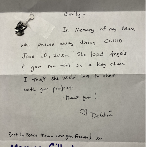A photo of an angel key chain and a description of the memento