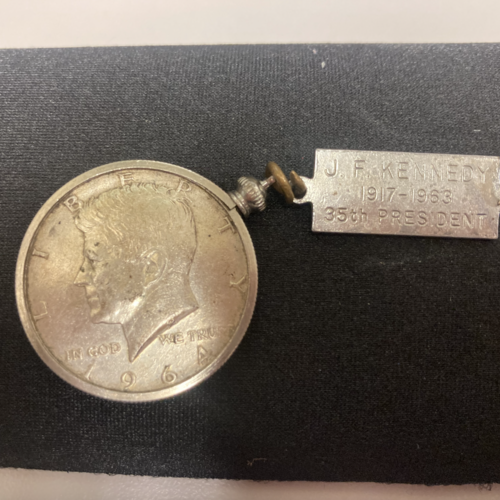 A photo of a gold coin with 35th US president J.F. Kennedy stamped across the front
