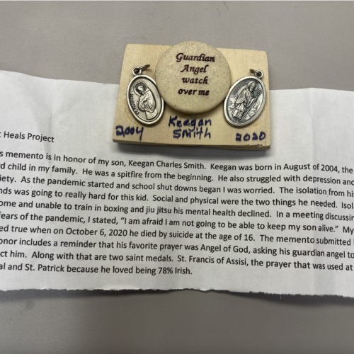 Photo of two saint medals and memento description
